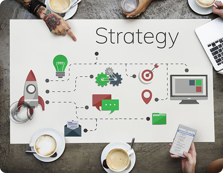 Tabletop displaying "Strategy" with icons representing marketing elements like a rocket, light bulb, gears, computer, and communication tools, surrounded by coffee cups and hands, illustrating collaborative planning for future-proof marketing strategies.