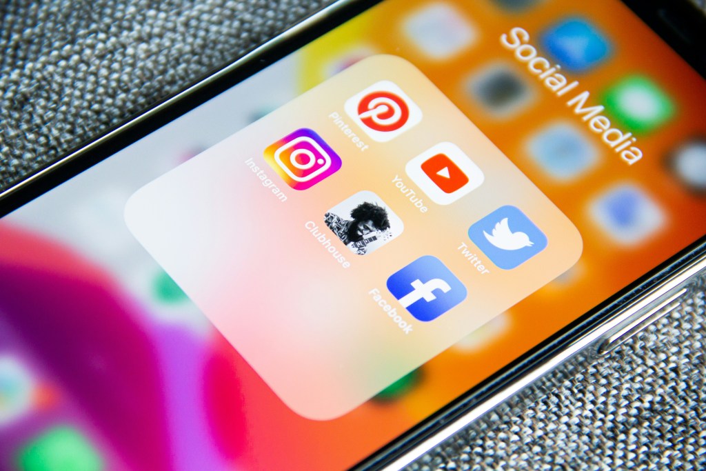 Social media app icons on smartphone screen, including Instagram, YouTube, Twitter, Facebook, and Pinterest, emphasizing digital marketing strategies for local business visibility.