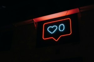 Neon sign displaying a heart and zero, symbolizing social media engagement, relevant to digital marketing strategies and trends for 2026.